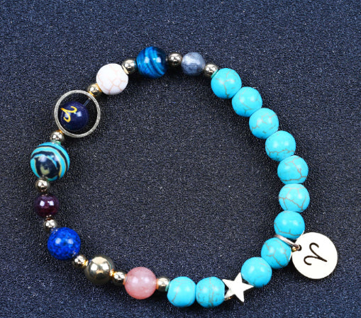 Turquoise beaded bracelet with mixed beads, zodiac charm disks, and a small star charm