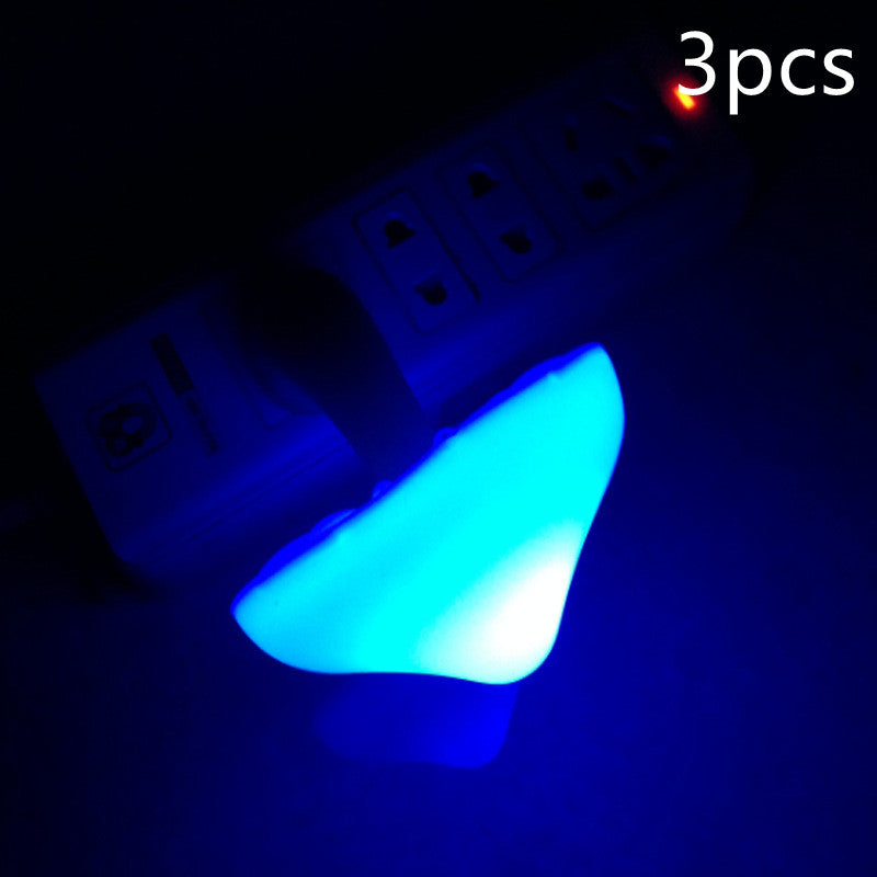 Mushroom night light wall plug lamp with blue glowing mushroom head, close view