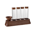 Clear glass tubes with cork lids in a wooden coffee bean display stand with a funnel cup