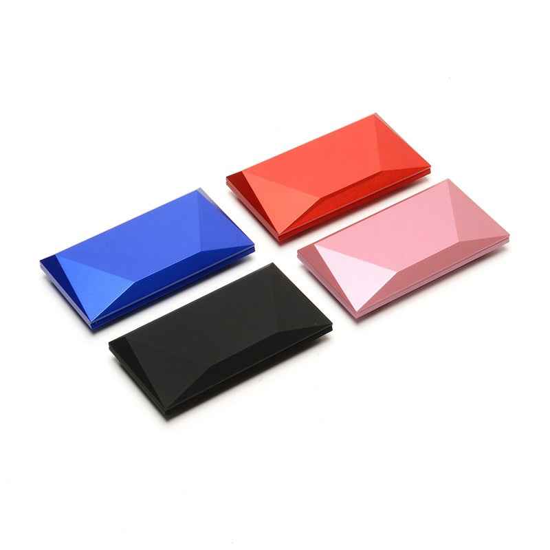Diamond-shaped ring boxes set with folded lids in blue, red, pink, and black
