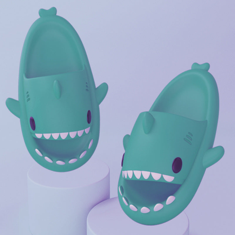 Cartoon shark slippers pair in teal, padded slide-on with toothy row