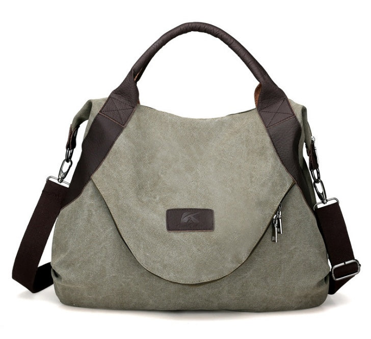 Olive green canvas shoulder crossbody bag with dark brown handles and side zippers