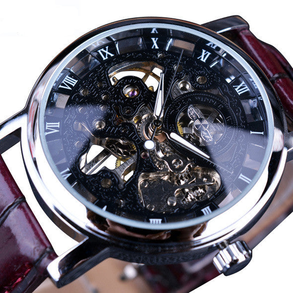 Mechanical watch with dark skeleton dial, Roman numerals, and maroon leather strap