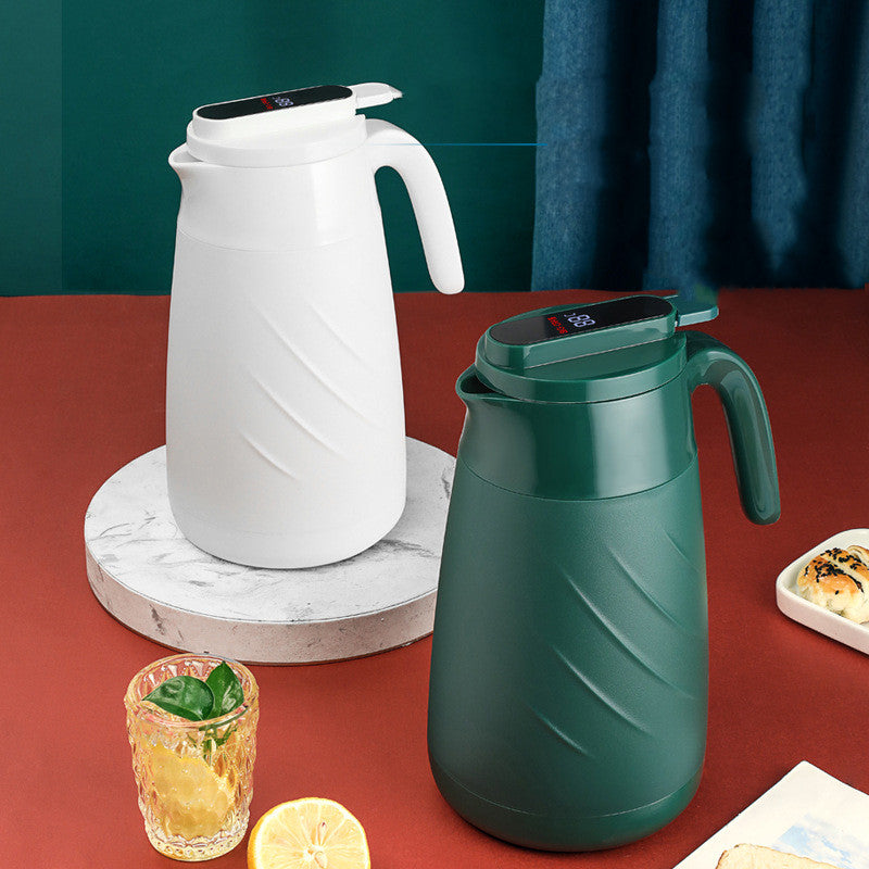 White smart water bottle beside green bottle with handle and digital lid top