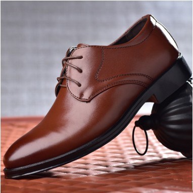 Men's pointed-toe lace-up dress shoes, brown leather upper and dark rubber sole.