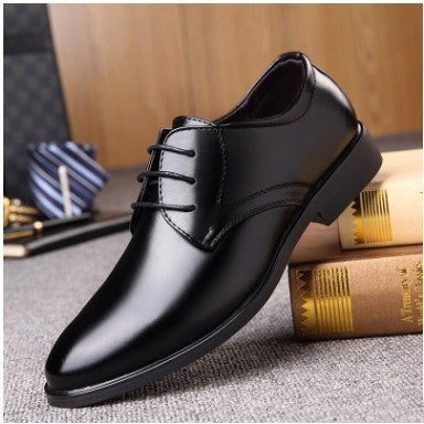 Men's pointed-toe lace-up dress shoe, black leather upper with low profile sole.