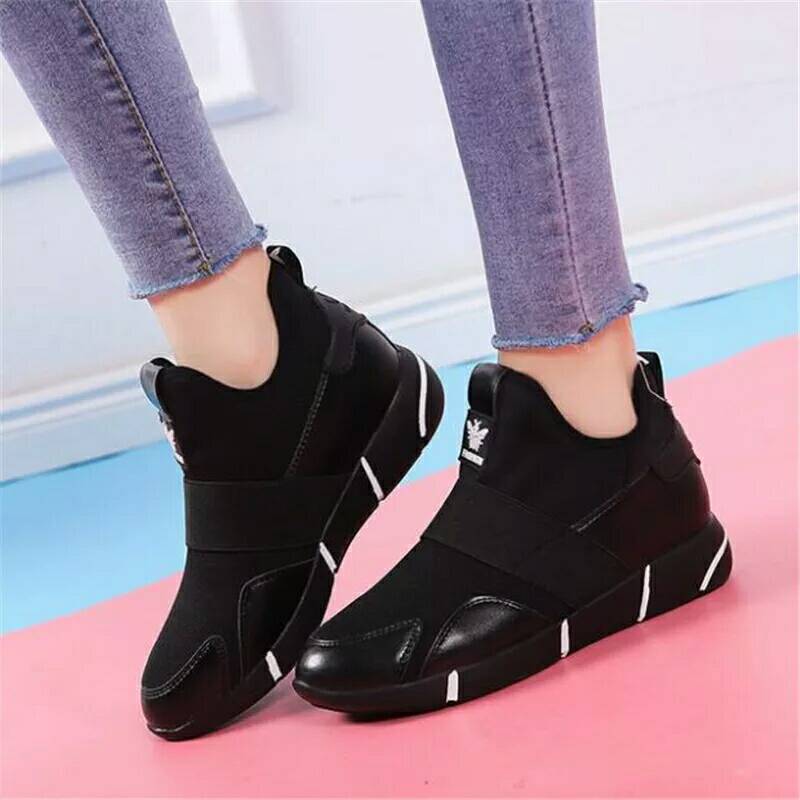 Black high-top slip-on shoes with contrast sole and white piping on heel