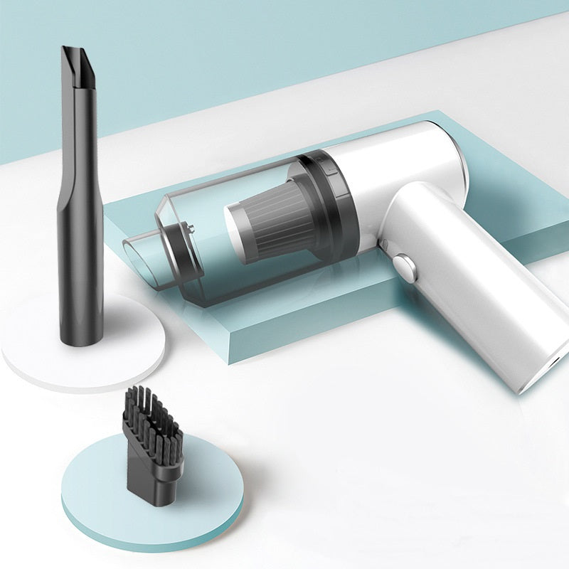 Wireless car vacuum cleaner with black handheld body and crevice tool attachment.