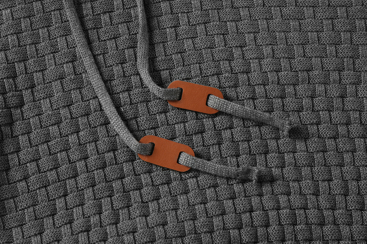 Men's hoodie sweater, gray textured knit close-up of drawcord tips and hood edge
