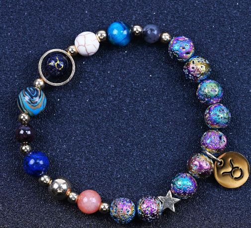 Beaded bracelet with blue stones, pink accent bead, rainbow speckled beads, star charm, zodiac disc.