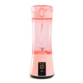 Pink portable electric fruit juicer with clear blending cup and pink lid