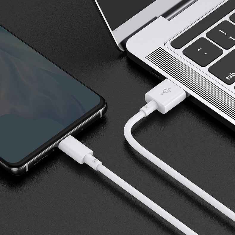 White charging cable connecting smartphone and laptop through USB ports