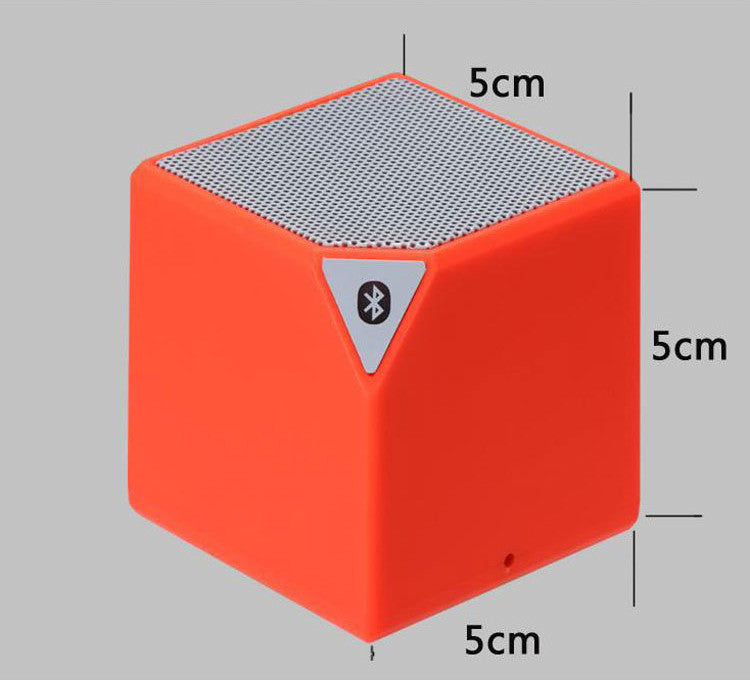 Orange Rubik's Cube Bluetooth speaker front face with top grille and small side port