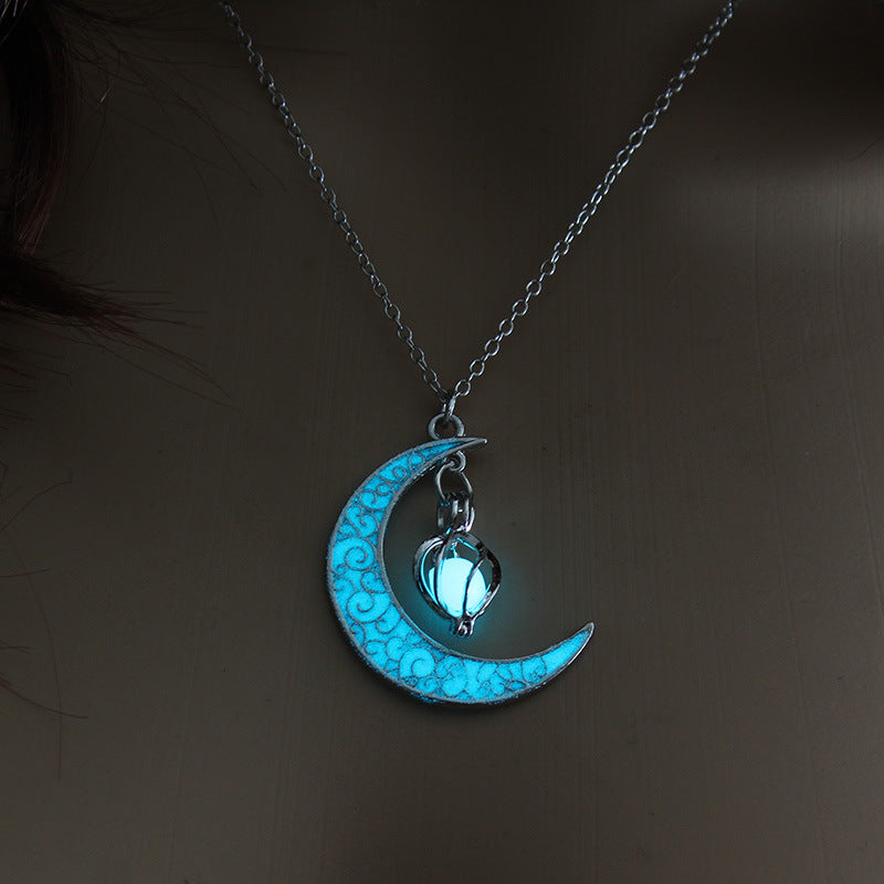 Crescent moon pendant necklace with blue glowing cat paw on a silver chain