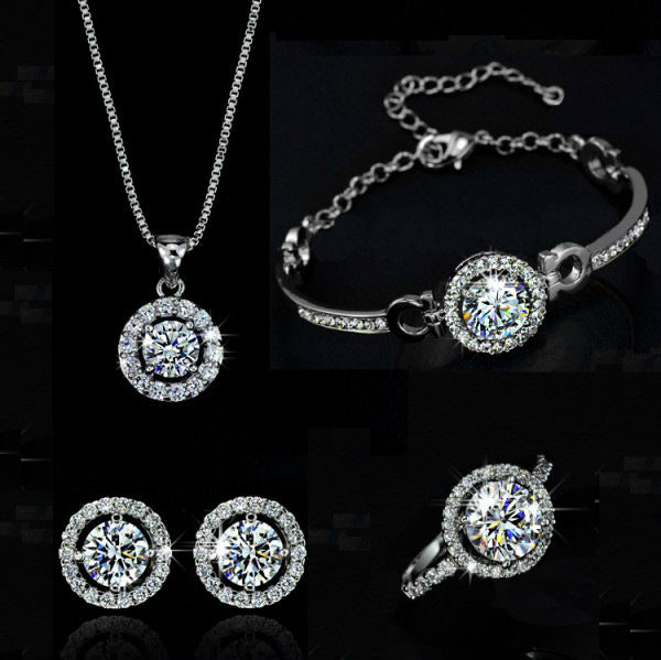 Silver jewelry set with round pendant necklace, curb bracelet, and matching stud earrings