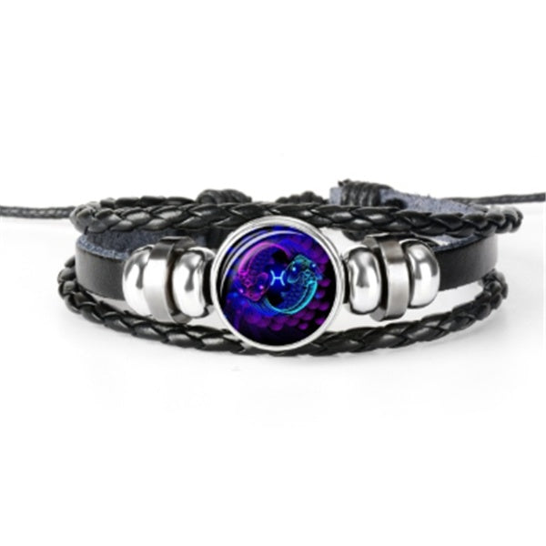 Braided bracelet with a centered round luminous zodiac charm in a metal bezel.