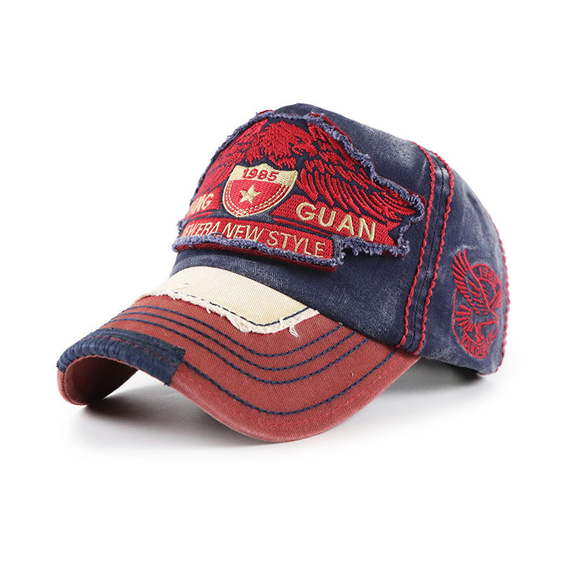 Baseball cap in navy blue with red crown embroidery; GUAN front patch and side badge