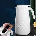 White smart water bottle with curved handle and closed lid, digital display visible