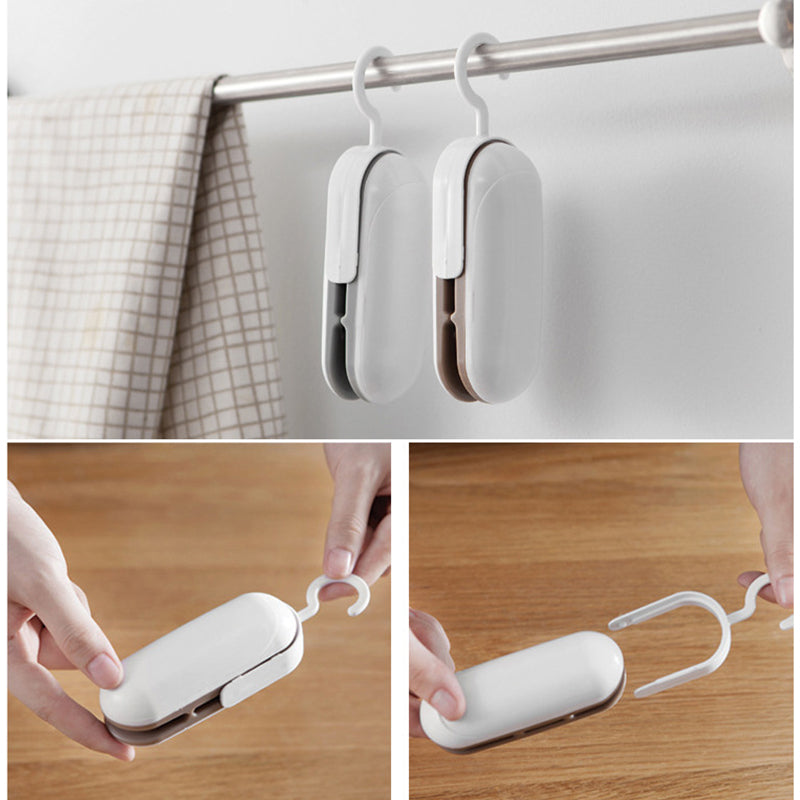 Mini portable heat sealer with white hinged design, hanging hooks and handheld use