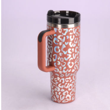 Insulated tumbler with handle, orange and white leopard pattern, stainless lid and straw