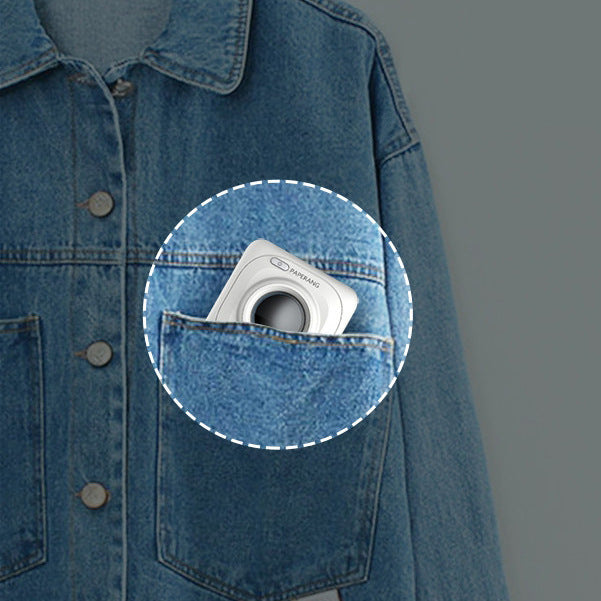 Mini thermal photo printer tucked into a blue denim jacket pocket
