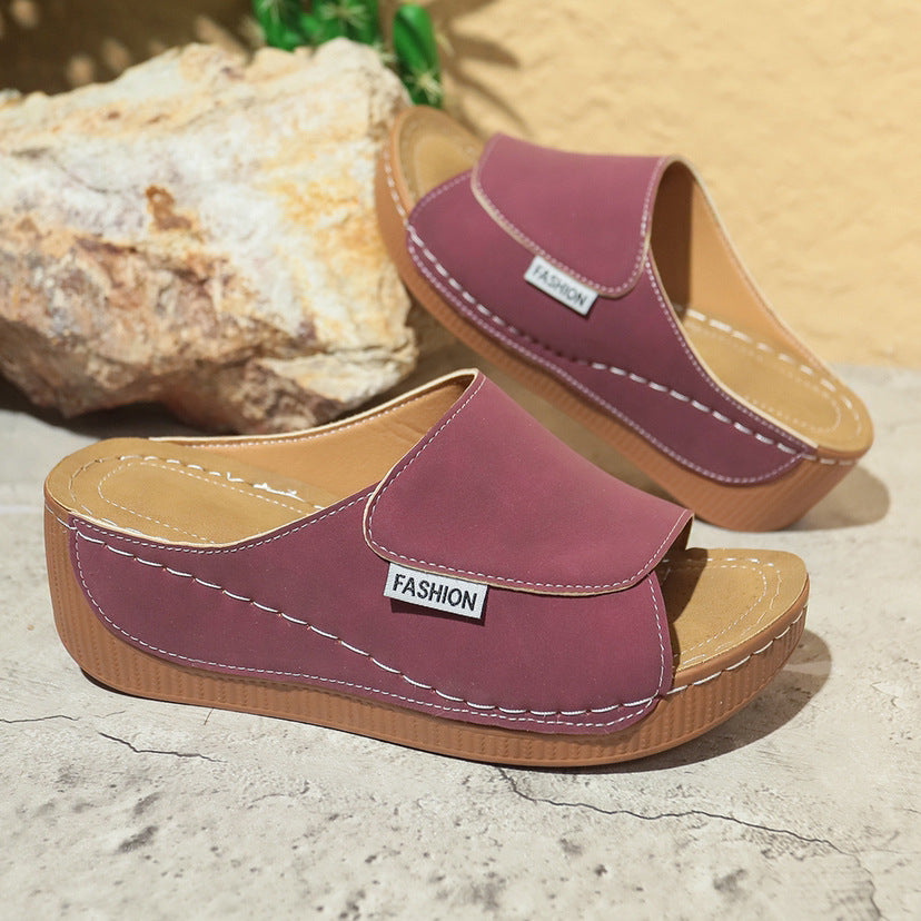 Women’s maroon wedge slide sandals with open toe, thick sole and white stitching