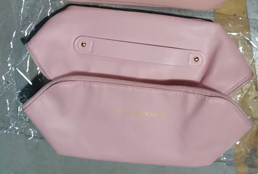 Large travel cosmetic bag in pink with front button and interior pocket opening
