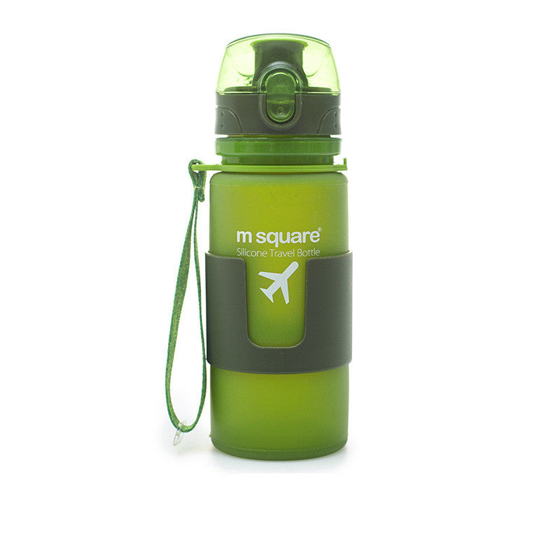 Silicone travel water bottle in green with carry strap and flip-up spout