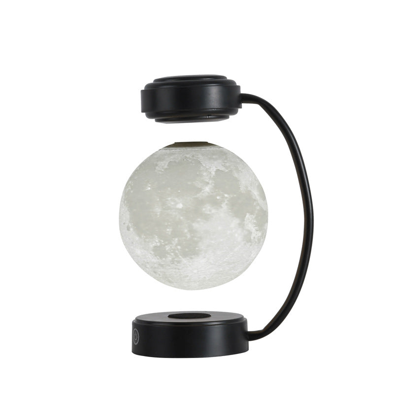 Black moon LED night light with glowing floating globe and round magnetic base