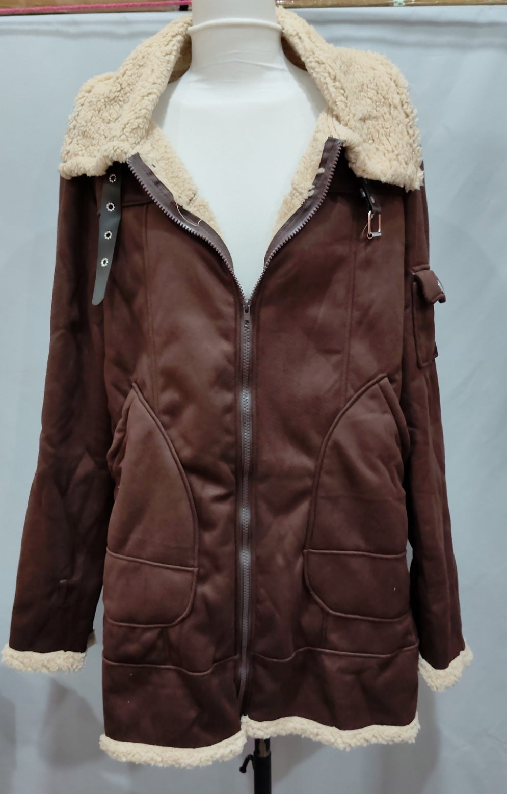 Men's winter jacket on mannequin, brown coat with cream fleece lining, zip-front