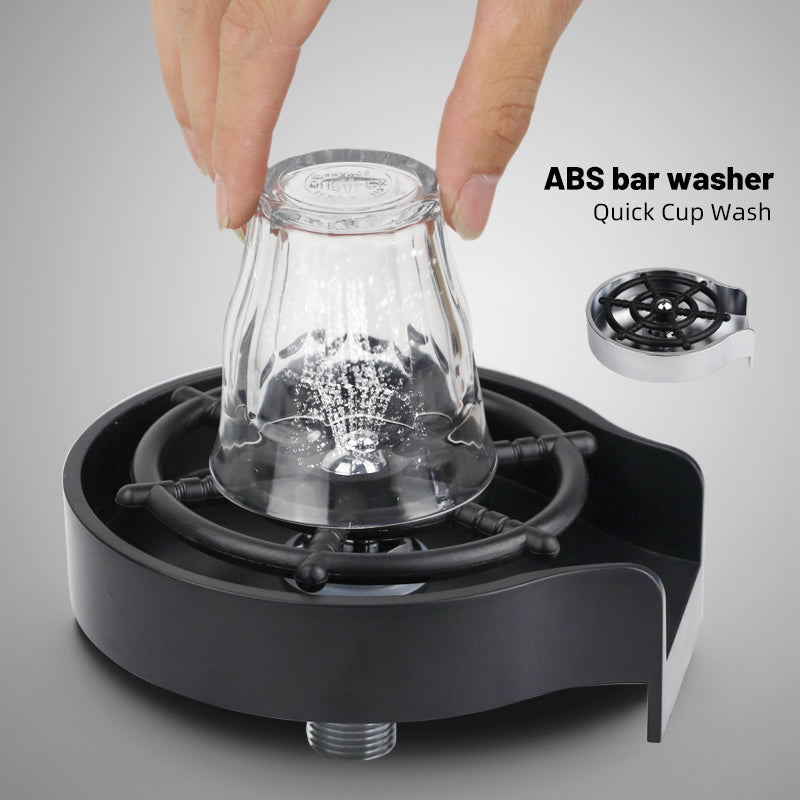 Cup washer with black base and rotating nozzle rinsing a clear glass pitcher
