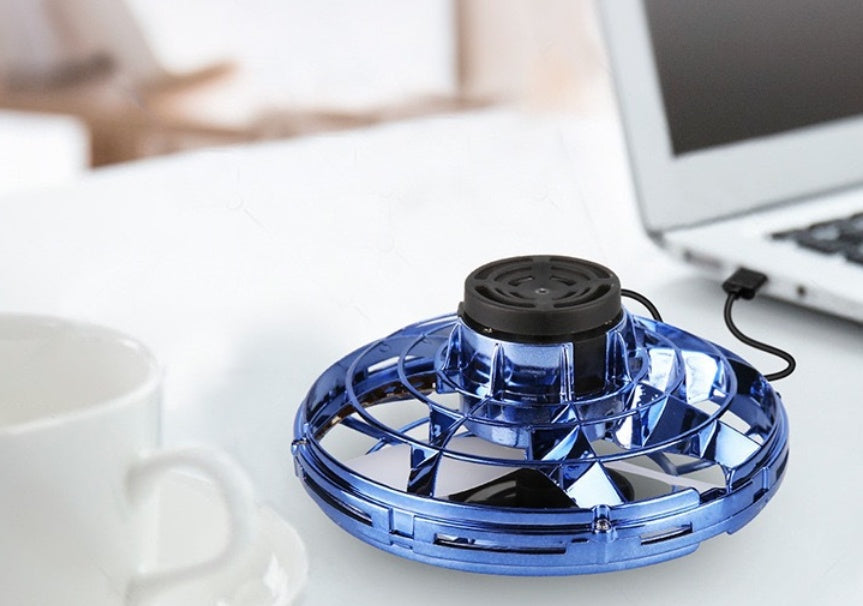 Blue UFO spinning toy drone with black top and CHG label