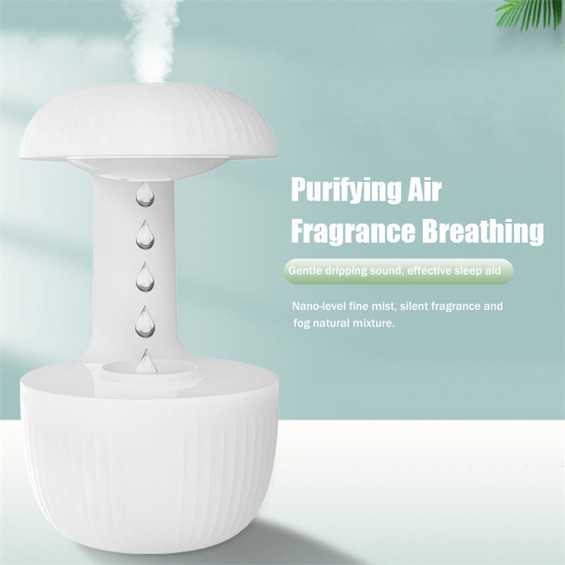 White cool mist humidifier with water droplets suspended above the tank opening.