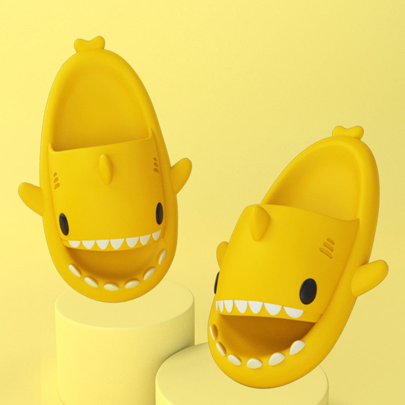 Cartoon shark slippers pair in yellow, chunky sole with cartoon shark face