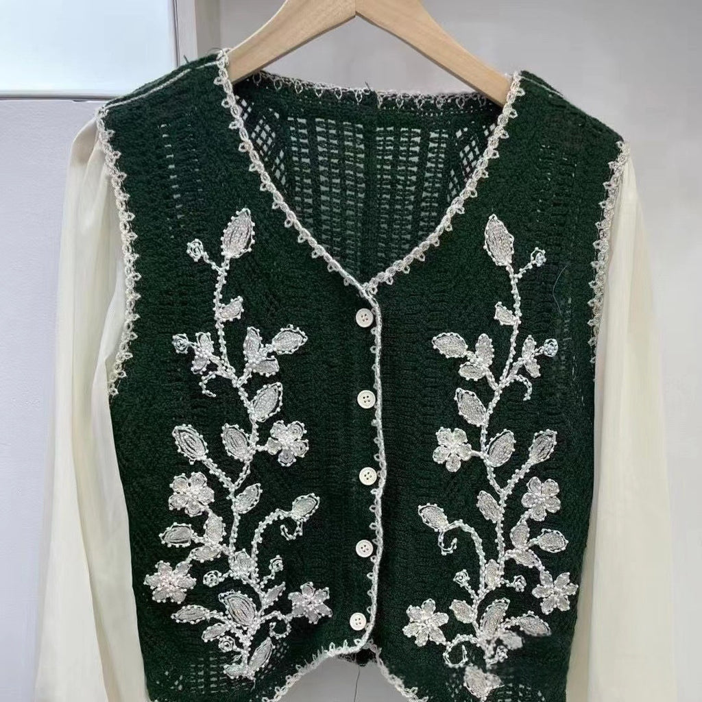 Dark green V-neck embroidered sleeveless top with floral vine pattern and button front