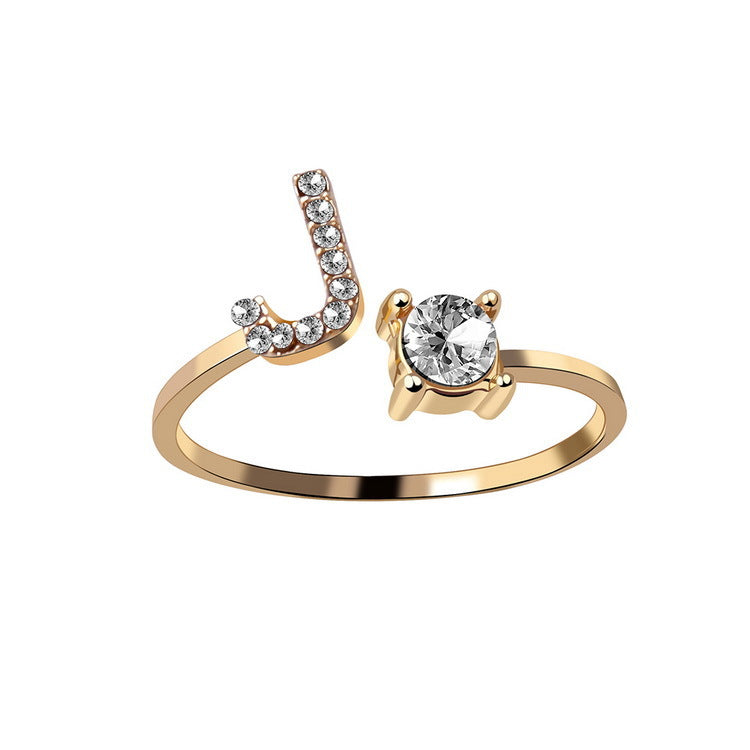 Gold tone initial J ring with round crystal center and pave J detail