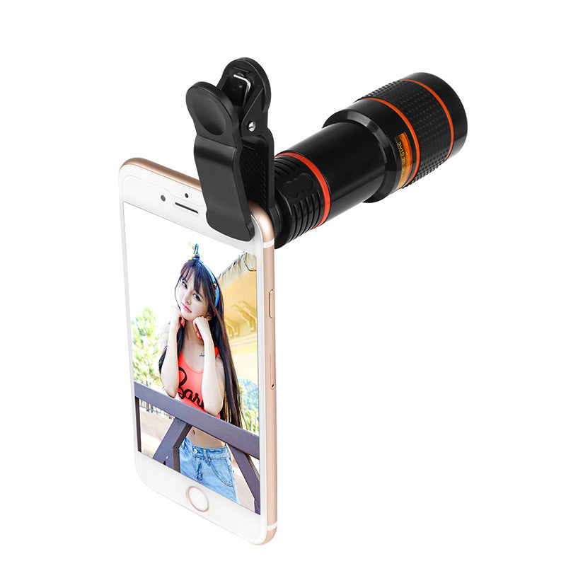 Black clip-on telescope camera lens attached to smartphone with orange ring barrel