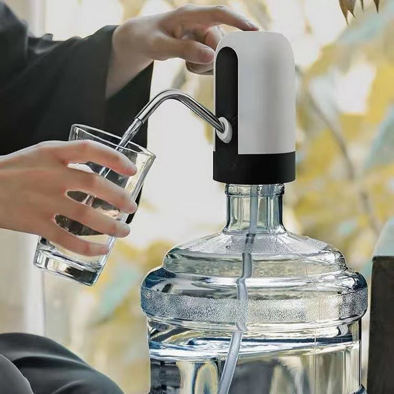 Automatic electric water bottle pump dispensing water into a glass with white and black body