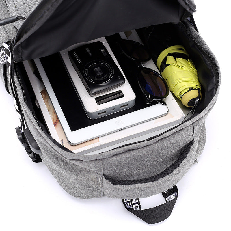 Open gray laptop backpack interior with device pockets and a bottle in the side compartment