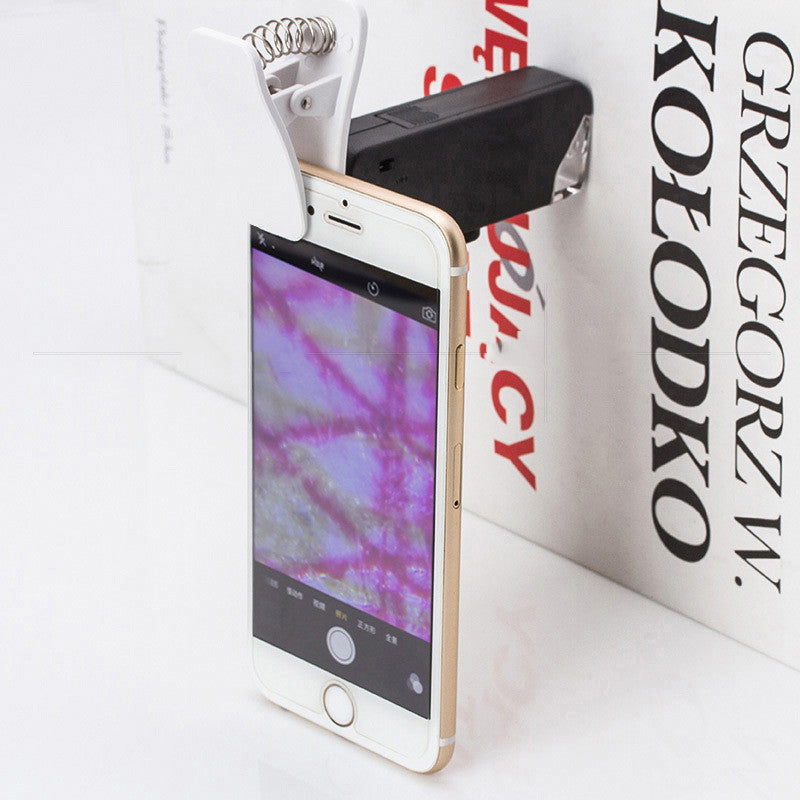 Phone clip-on microscope magnifier attachment with black clip and mounted lens