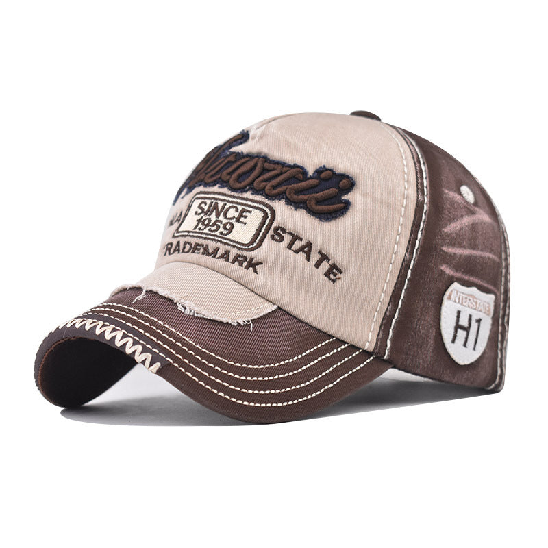Tan and brown baseball cap with embroidered “Since 1959” and “HI” badge on side