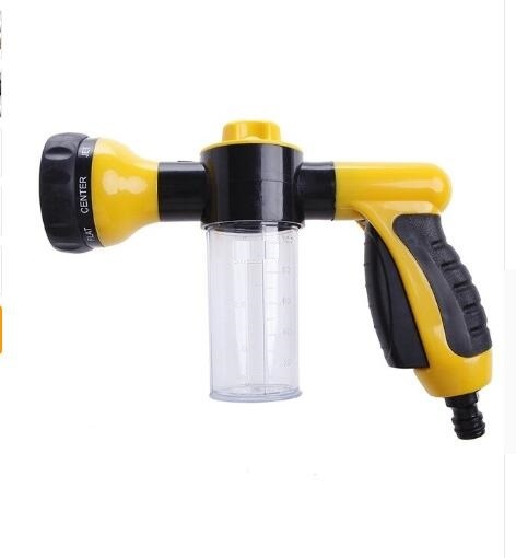High-pressure foam spray gun with clear cup, yellow nozzle head, and black trigger