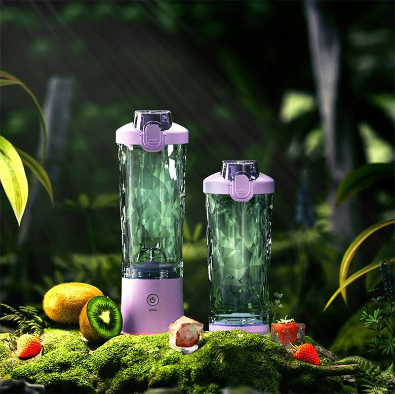 Portable blender set in light purple with two green blending cups on surface