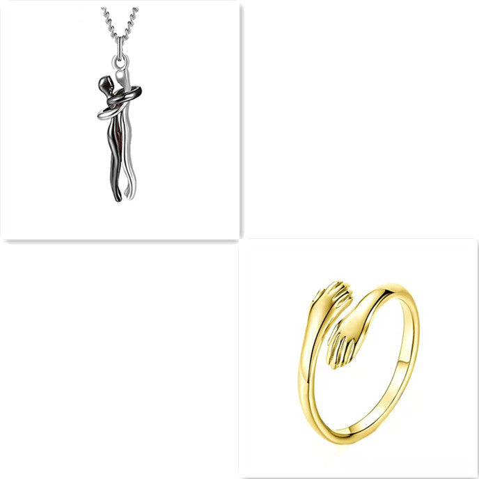 Silver hug-pendant necklace on chain with gold-tone ring, polished metal design