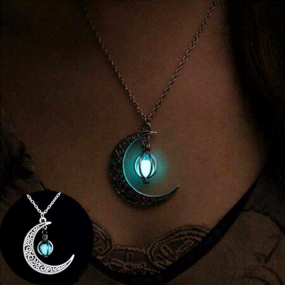 Silver crescent moon pendant necklace with glowing teal stone on a chain