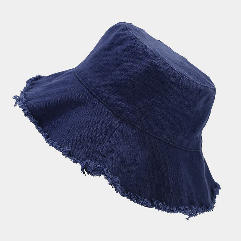 Navy blue sun hat with wide brim and frayed edge trim.