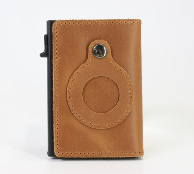 Men's slim card wallet in tan leather with round tag holder and stitched border.