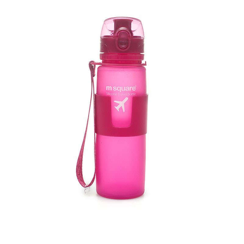 Pink silicone travel water bottle with carry strap and flip-up drinking spout