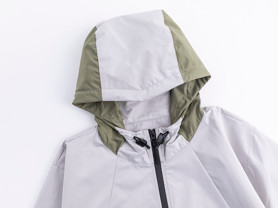 Close-up hooded assault suit jacket, white front with military green hood and black drawcord