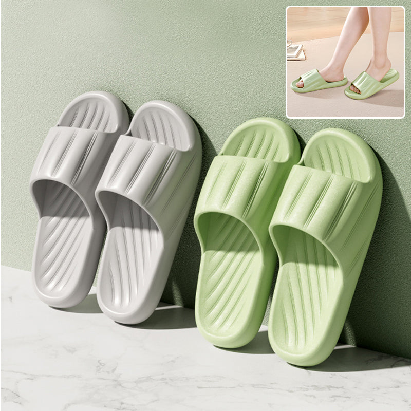 White and light green slide slippers with striped strap and ribbed footbed